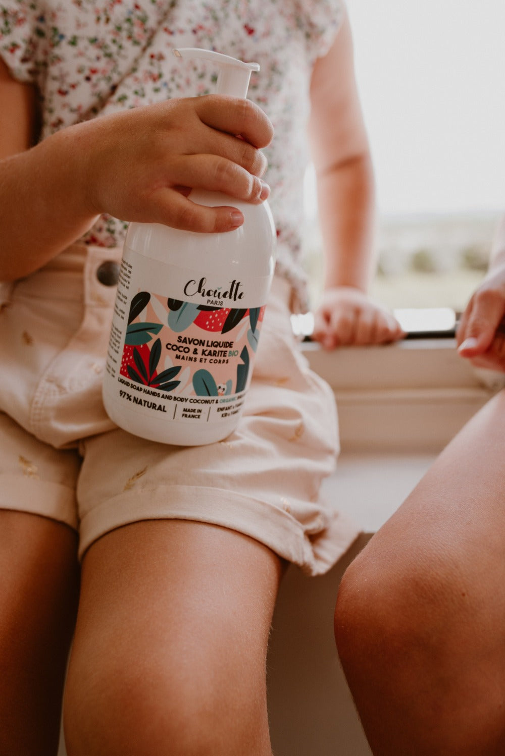 deux enfants parelnt ensemble et l'un tient dans les doigts le flacon de savon liquide fabriqué en Provence et eco responsable 